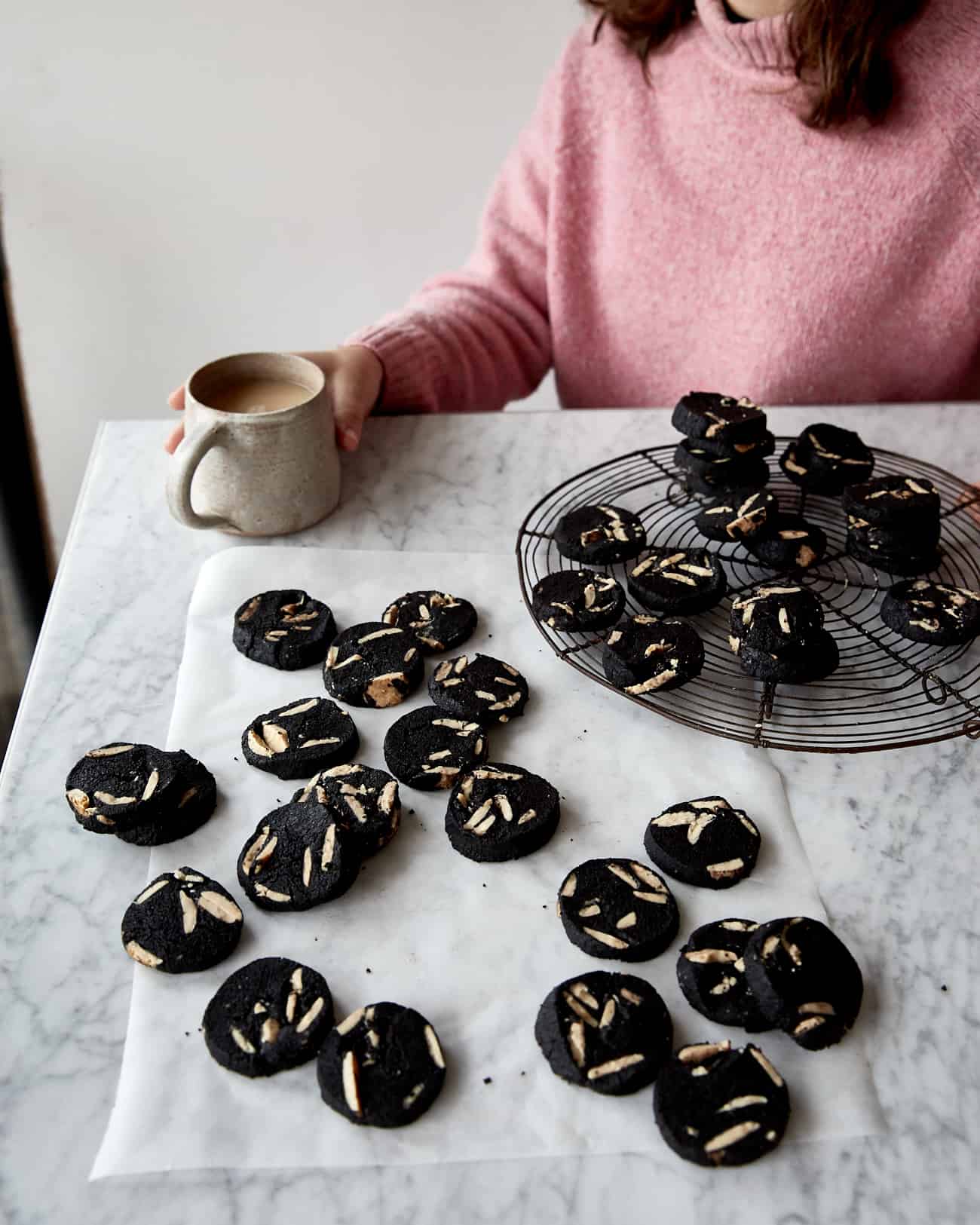 Cookies & cream shortbread on a marble table with a person wearing a pink jumper