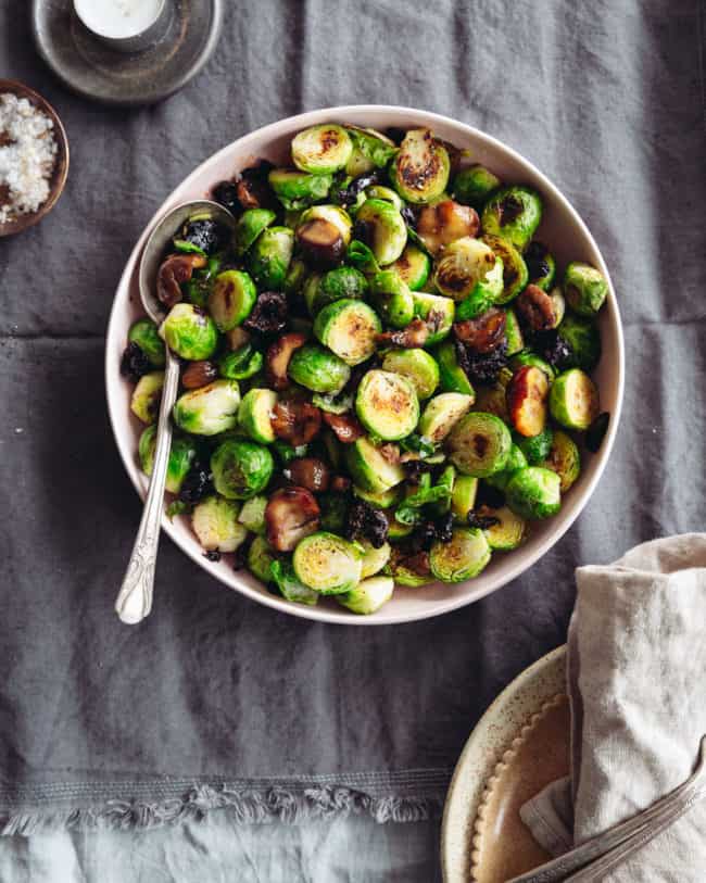 a bowl of pan roasted Brussels sprouts with chestnuts and olives