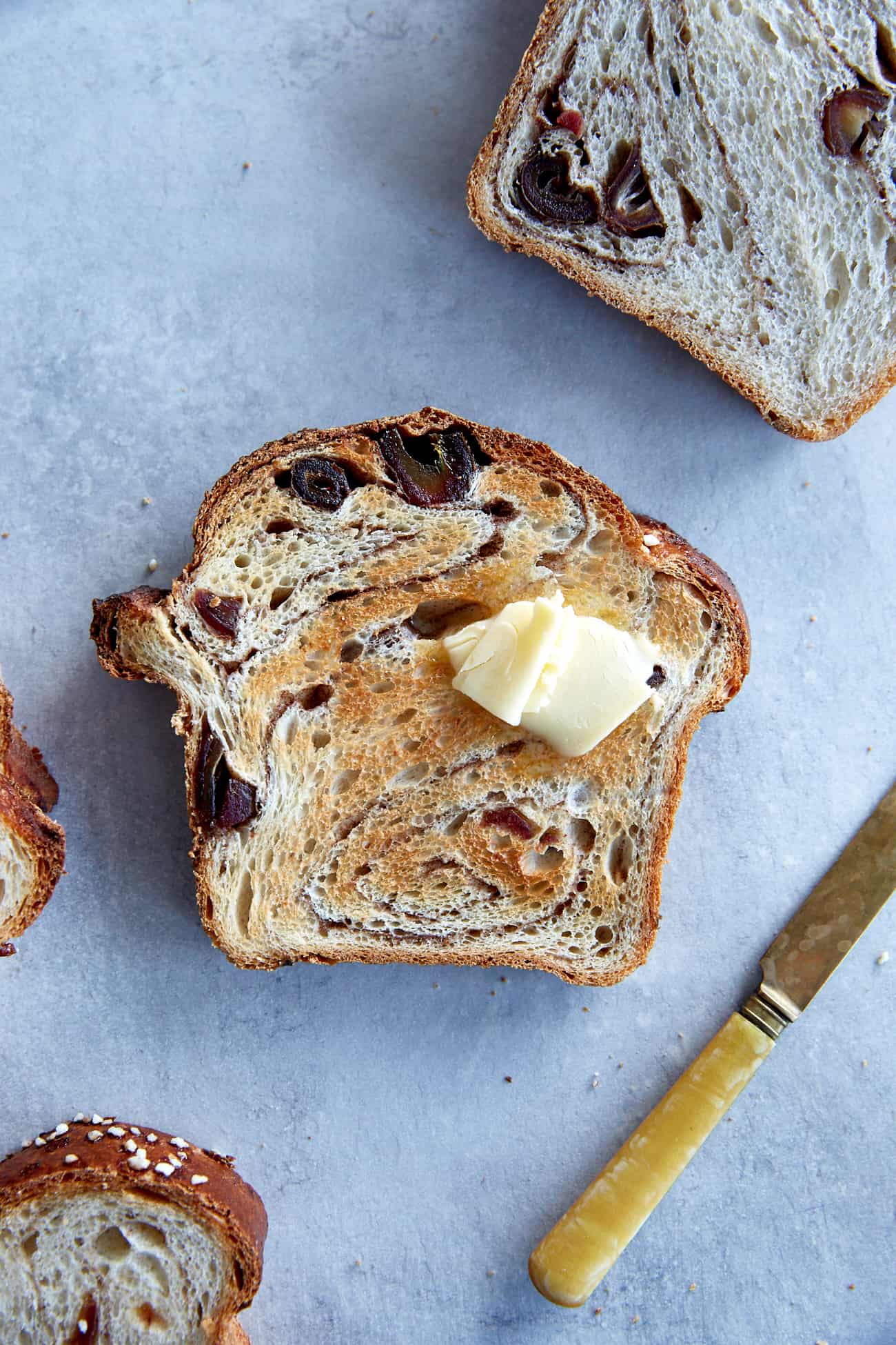 a close up of a slice of cinnamon swirled sourdough with butter