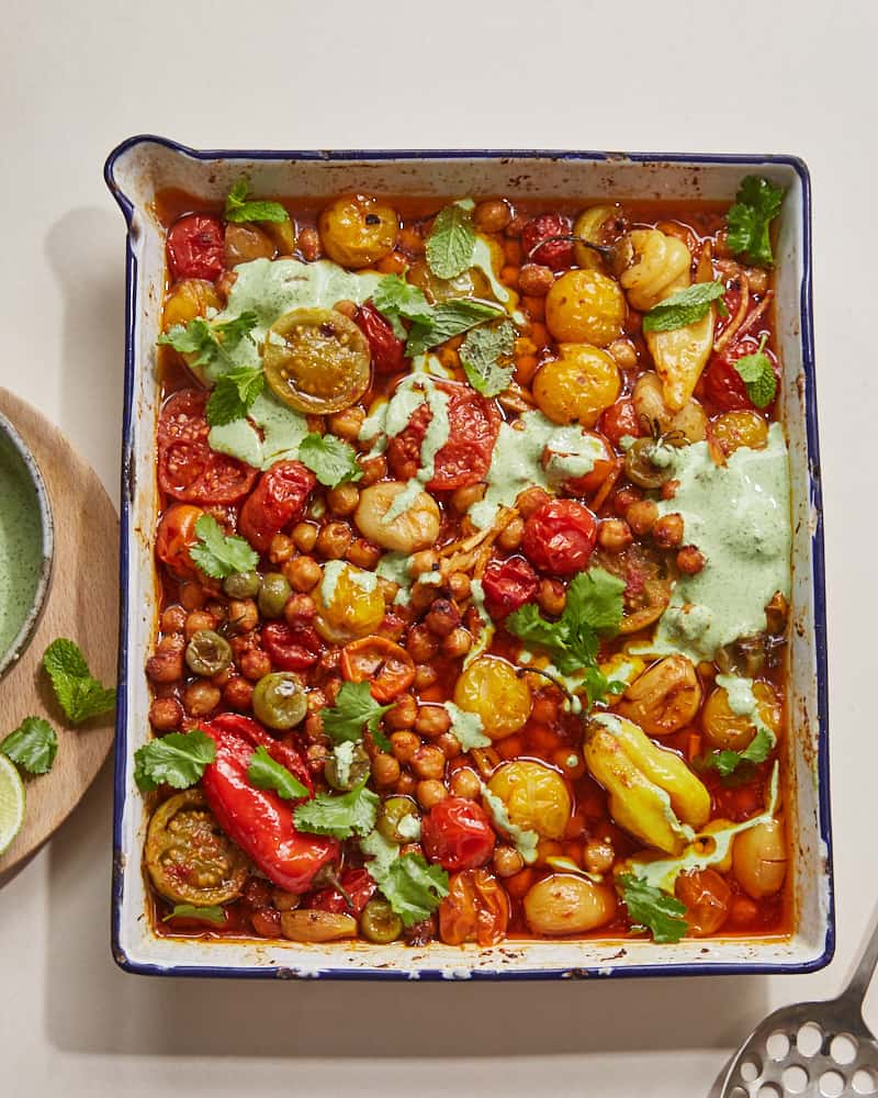 confit tandoori chickpeas drizzled with herbed yoghurt in a roasting tray