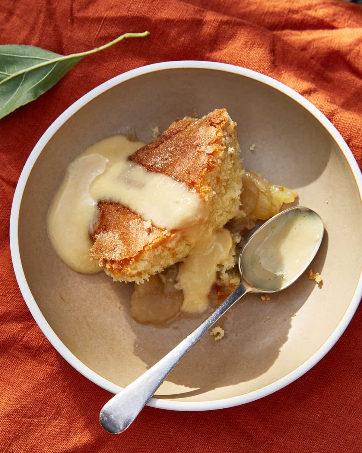 A scoop of Mother Eve's pudding in a bowl with custard