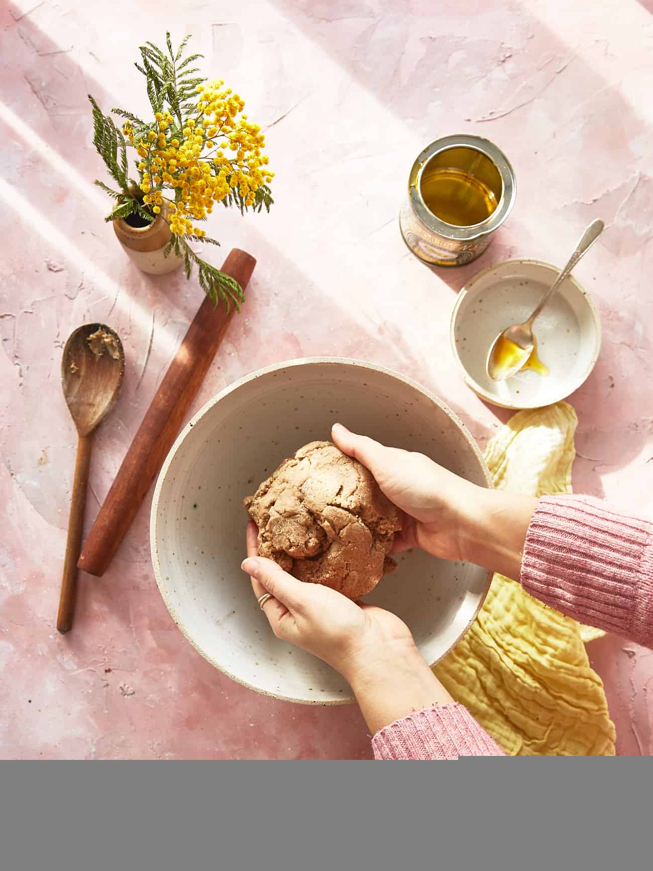 homemade graham cracker dough with hands holding it