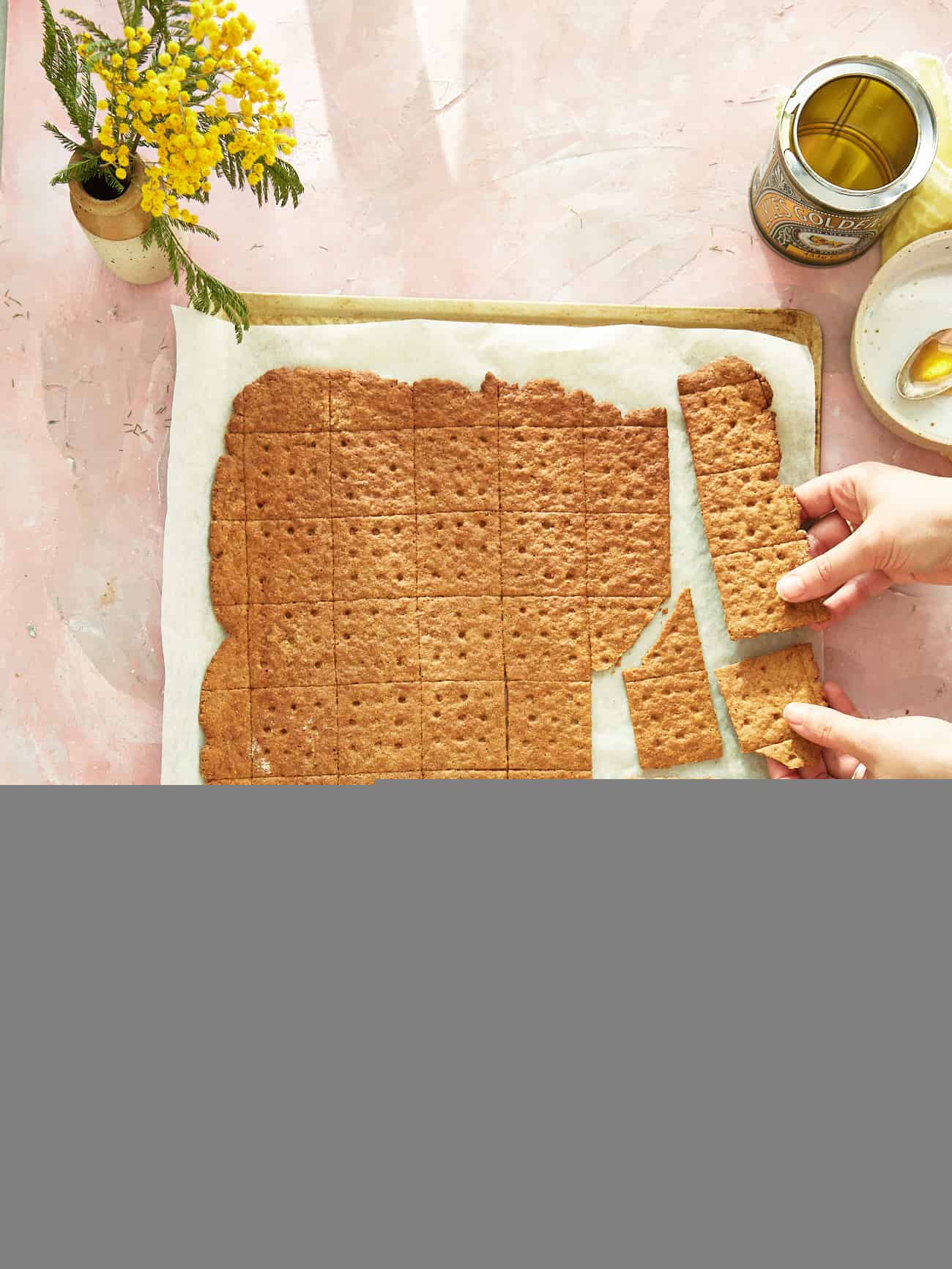 snapping a large homemade graham cracker sheet into smaller crackers