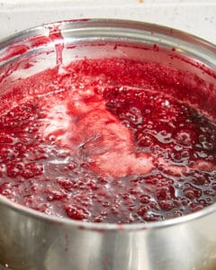 damson jam cooking with smaller bubbles