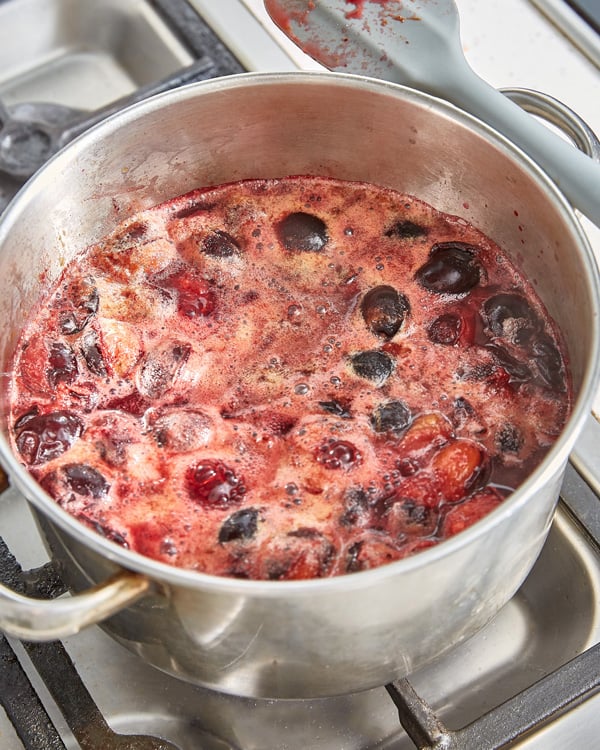 damsons simmering with water in a pot