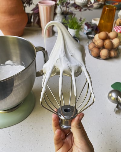 stiff glossy meringue on a whisk