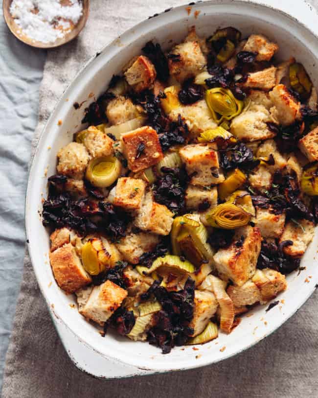 a baking dish with vegan stuffing with leeks and caramelised mushrooms