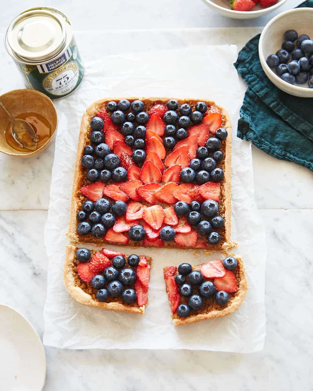 a treacle tart topped with berries in the shape of the union jack