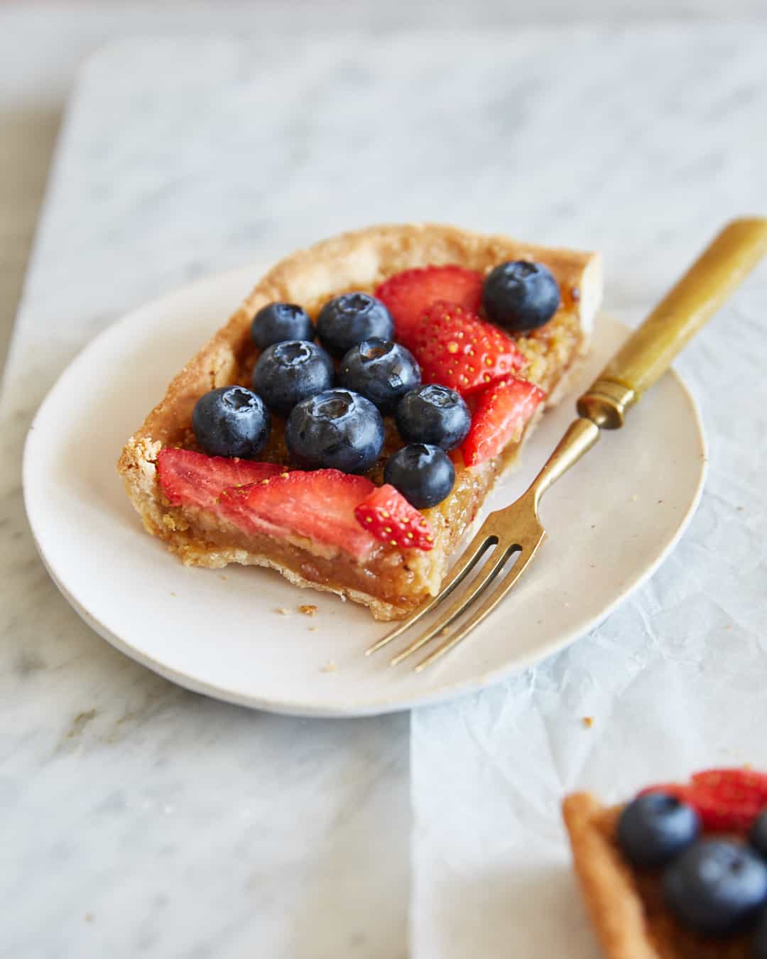 a slice of treacle tart topped with berries