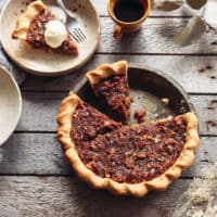 pie tin with vegan maple pecan pie and a slice taken out