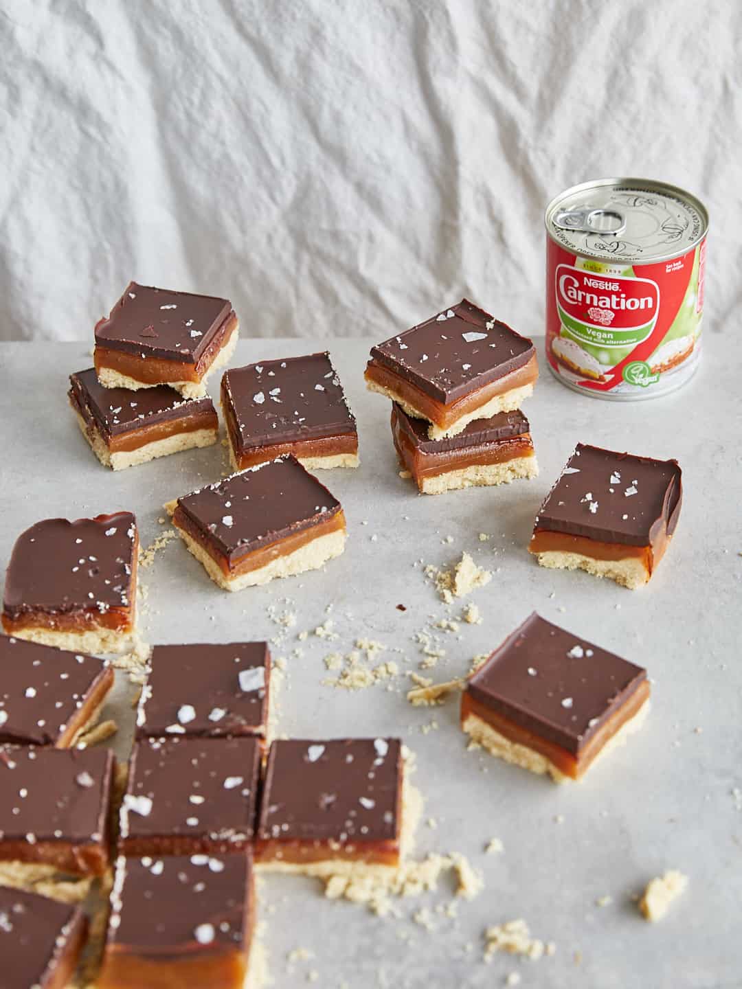 squares of vegan millionaires shortbread made using carnation vegan condensed milk