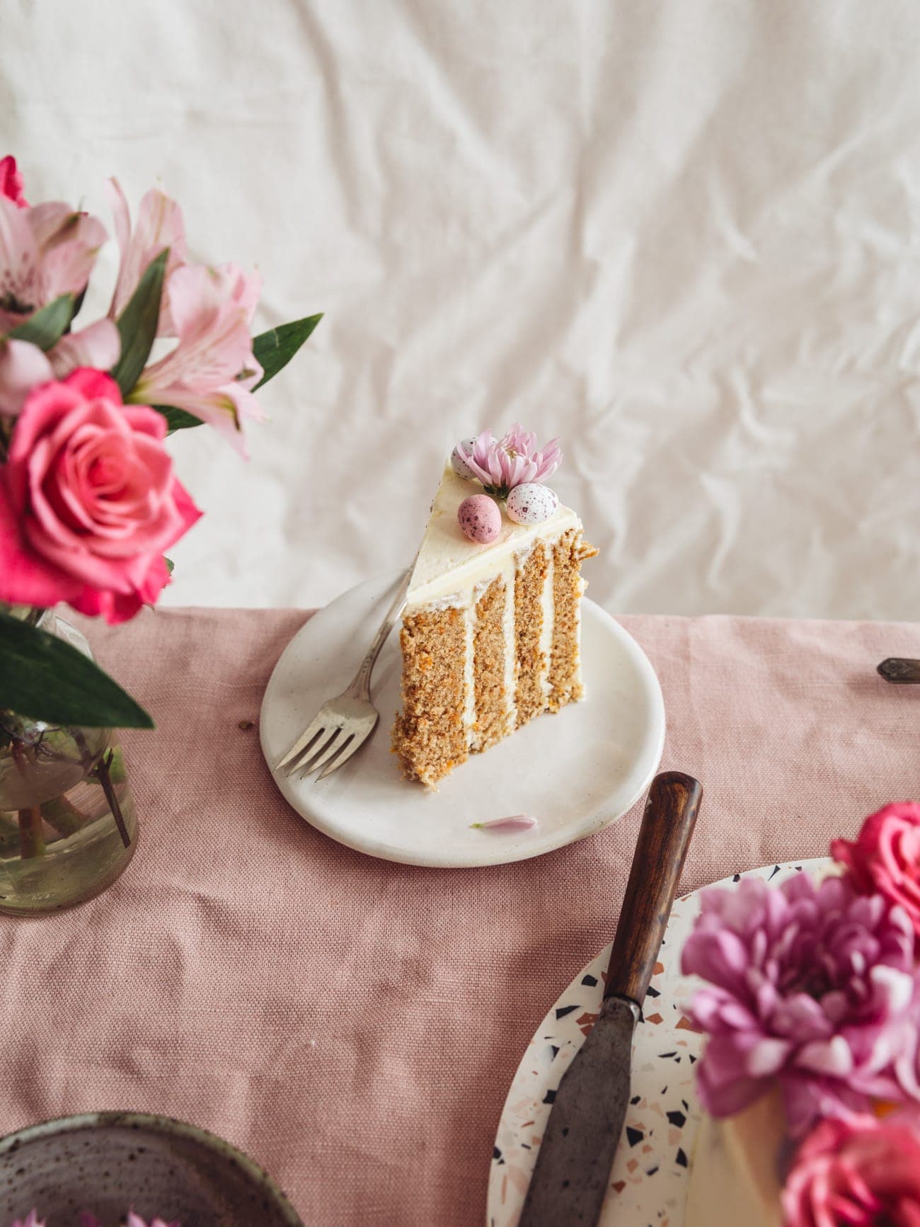 A slice of Vertical Layer Carrot Cake with vanilla Swiss Meringue Buttercream by Izy Hossack