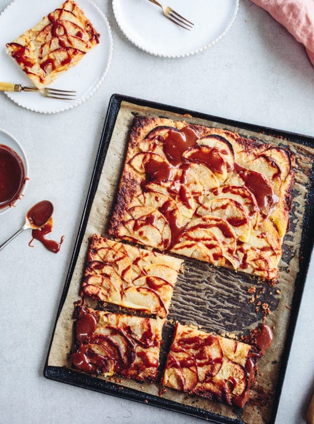 A sliced apple tart drizzled with tahini caramel